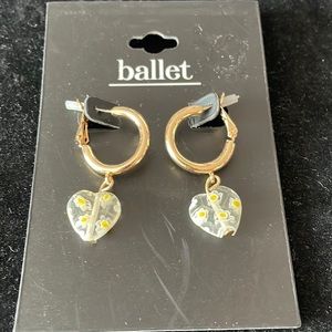 Ballet gold tone hoop pierced earrings with faux yellow stone.